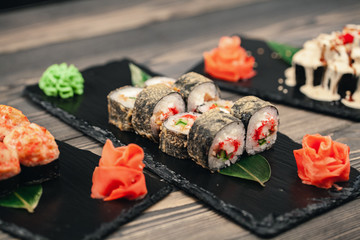 Healthy food. Japanese restaurant. Sushi roll on a black background