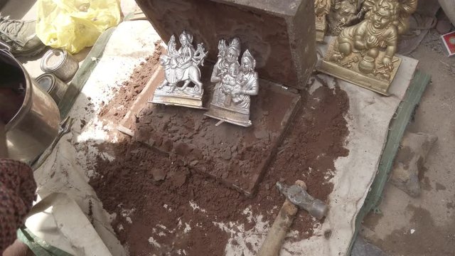 Indian mythological Gods and Goddesses metal figurines being manufactured in recycled metal before the arrival of major Hindu festivals and celebrations across India 4k slow-motion handheld stabilized