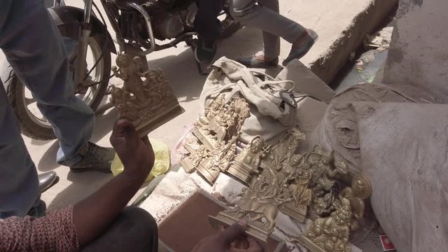 Indian mythological Gods and Goddesses metal figurines being manufactured in recycled metal before the arrival of major Hindu festivals and celebrations across India 4k slow-motion handheld stabilized