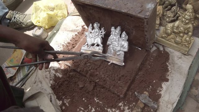 Indian mythological Gods and Goddesses metal figurines being manufactured in recycled metal before the arrival of major Hindu festivals and celebrations across India 4k slow-motion handheld stabilized