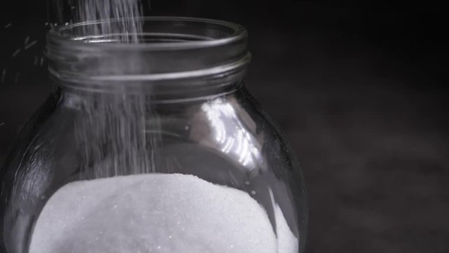 White salt falling into bottle
