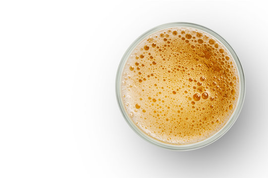 top view of beer bubbles in glass cup on white background. empty space for design.