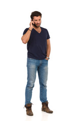 Fototapeta premium Pensive Handsome Man Talking On The Phone And Looking Away