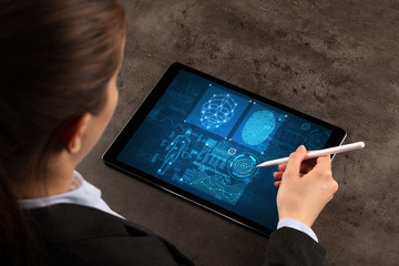 Business woman making analyses and checking fingerprints on tablet

