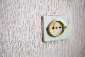 Electricity short circuit. Electrical failure resulting in old electricity socket burnt