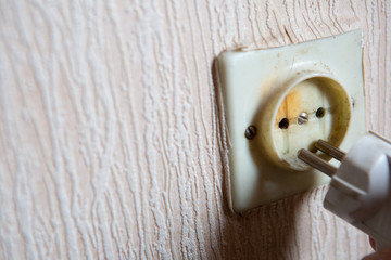 Electricity short circuit. Electrical failure resulting in old electricity socket burnt