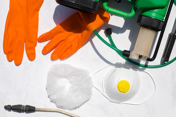 Protective tools for spary pesticides on the white surface.Top view of professional equipment for farmer  spraying pesticide