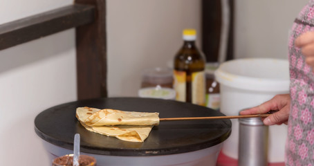 Prepare crepes on a hot plate and fold with a wooden spoon