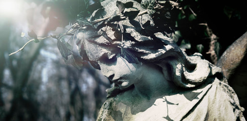 Fototapeta na wymiar Ancient statue of antique retro styled angel