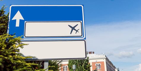 Overhead road direction signs showing way to airport