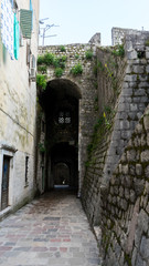 The narrow street of the authentic old town of Kotor, Montenegro. Old traditional stone houses. picturesque medieval street in the old town district of the coastal city in the adriatic sea.