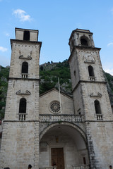 Fototapeta na wymiar Old church inside Stari Grad, Kotor, Montenegro. Kotor bay and Old Town from Lovcen Mountain. Montenegro. Tower with mountains in the background
