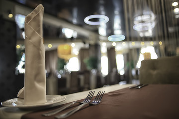 fork and knife serving in the interior of the restaurant / table in a cafe, food industry catering, menu