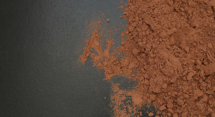 Cacao powder on black table with copyspace
