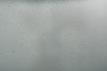 wet glass background condensate / abstract rain, drops texture on transparent glass