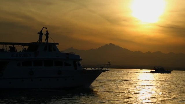 Dancing on a ship at sea under the setting sun