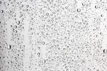 white isolated background water drops on the glass / wet window glass with splashes and drops of water and lime, texture autumn background