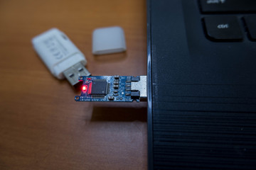 USB Drive without cover Light and plug in with notebook.Technology education storage breach concept.