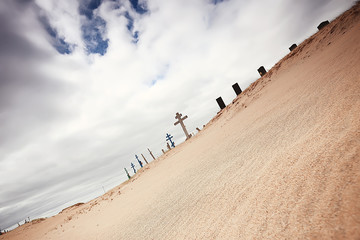 Fototapeta na wymiar grave crosses in a desert cemetery / climate change concept warming, disaster, apocalypse, Christian cemetery