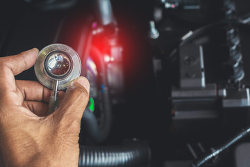 Asian man holding stethoscope car inspection Rubber tires car.Close up hand