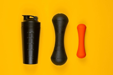 Gym equipment on yellow background