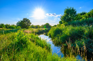 Blue sky over a little creek in the surrounding countryside of Berlin, Germany.