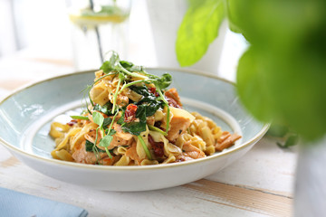 Spaghetti with salmon and sun-dried tomatoes. Appetizing dish