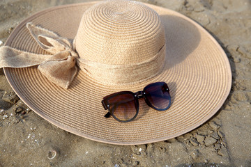 Hats and glasses placed on the beach 