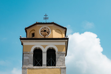 yellow bell tower with clock in Rijeka, Croatia