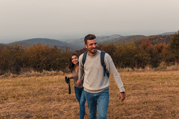 Young couple enjoying hiking together through the countryside.