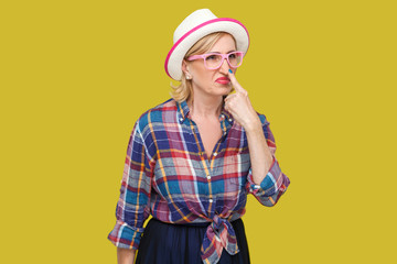 You are liar. Portrait of angry modern stylish mature woman in casual style with hat, eyeglasses...