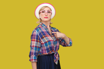 Because I am. Portrait of proud serious modern stylish mature woman in casual style with hat and...