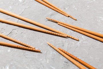 Many bamboo chopsticks on black cement stone background, top view with copy space. a lot of sushi...