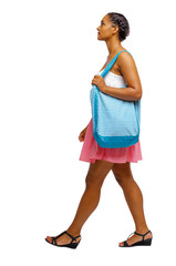 Side view of an African-American with a beach bag that goes to t