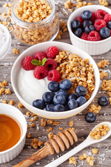 High protein and diet breakfast. Homemade granola crisp with raspberry, blueberry and greek yogurt. Top view.