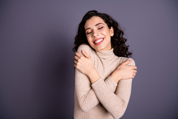 Close up photo amazing beautiful she her lady overjoyed toothy beaming smile eyes closed hold hands arms shoulders nice pleasant clothes wear casual pastel sweater pullover isolated grey background