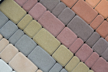 Multicolored paving slabs for road paving by mosaic on shop window. Construction