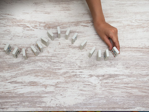 Domino Pieces Lined Up By The Hand Of A 6 Year Old Boy On A Wooden Background