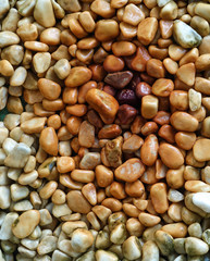 Top view and close-up of pebbles that are rust colored from the water drops that have been falling on them.