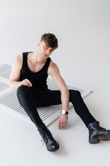 man in black sleeveless shirt sitting on grey