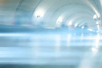 blurred background metro escalator / light blue background movement city infrastructure subway