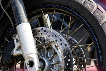 Front wheel, hub, spring and braking mechanism of a biker motorcycle. Road safety