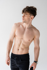 Fototapeta premium shirtless muscular man in wristwatch isolated on grey