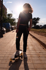 portrait of a teenager skater girl at the city