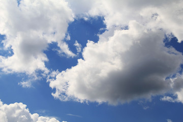 Fototapeta na wymiar magic volumetric clouds in the clear blue sky