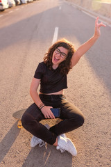 portrait of a teenager skater girl at the city