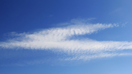 magic feathery clouds in a clear blue sky