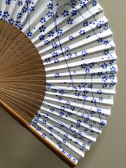 Japanese-style paper fan with blue sakura on white pattern