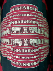 Traditional Thai handicraft fabric pattern, yellow elephants on red and black background