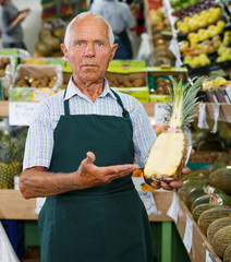 Owner of greengrocery offering fruits and vegetables